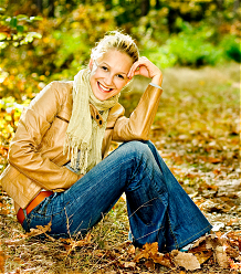 Woman sitting on leaves and smiling